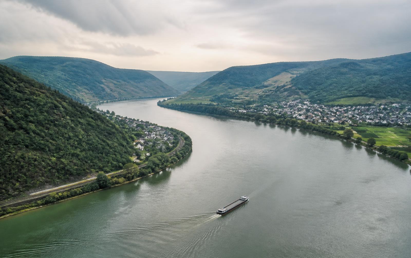 A river corridor running past a town and low farmland