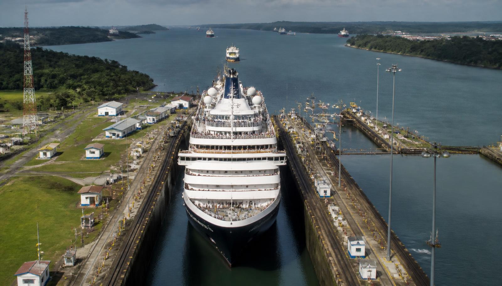 An ocean cruise ship in a canal transit between two seas, the kind of shortcut that changes how far a route can reach in a week.